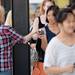 A Madewell employee passes out discount cards to shoppers standing in line outside of the store during the grand opening of Arbor Hills on Thursday, August 22, 2013. Melanie Maxwell | AnnArbor.com